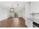 Bright living room featuring wood floors, shiplap accent wall, contemporary lighting, and sliding doors to outdoor area at 7020 E Girard Ave # 209, Denver, CO 80224
