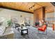 Bright community lounge area featuring a fireplace, multiple seating options, and a wood-paneled ceiling at 7020 E Girard Ave # 209, Denver, CO 80224