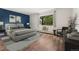 Comfortable primary bedroom featuring an accent wall and a window view at 7020 E Girard Ave # 209, Denver, CO 80224