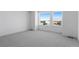 Bedroom with plush carpeting, large windows, and a view of a residential neighborhood at 14261 Currant St, Broomfield, CO 80020