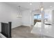 Bright dining area adjacent to the kitchen, features modern lighting and access to the patio for seamless indoor-outdoor living at 14261 Currant St, Broomfield, CO 80020