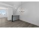 An elegant dining area is illuminated by a modern chandelier and complemented by sleek gray floors and abundant natural light at 14261 Currant St, Broomfield, CO 80020