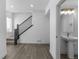 Open entryway with staircase and sleek powder room featuring pedestal sink and modern fixtures, perfect for welcoming guests at 14261 Currant St, Broomfield, CO 80020