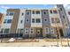 Contemporary townhome with mixed brick and gray siding, complemented by a landscaped front yard with a walkway at 14261 Currant St, Broomfield, CO 80020