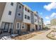Modern townhome complex showcasing neutral-toned siding, a well-kept walkway, and meticulously maintained landscaping at 14261 Currant St, Broomfield, CO 80020