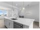 Kitchen island features stainless steel dishwasher and a marble countertop with sink at 14261 Currant St, Broomfield, CO 80020