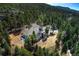Stunning aerial view of a home nestled among lush green trees, showcasing its serene and secluded location at 26806 Evergreen Springs Rd, Evergreen, CO 80439