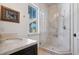 Modern bathroom with a glass-enclosed shower and marble countertops at 26806 Evergreen Springs Rd, Evergreen, CO 80439