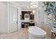 Bright bathroom with soaking tub, dark wood vanity, and elegant fixtures at 26806 Evergreen Springs Rd, Evergreen, CO 80439