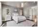 Neutral bedroom with a tufted headboard and lots of natural light at 26806 Evergreen Springs Rd, Evergreen, CO 80439