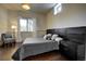 Cozy bedroom with hardwood floors, a large window offering natural light, and modern dark wood furniture at 26806 Evergreen Springs Rd, Evergreen, CO 80439