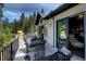 Spacious outdoor deck area featuring elegant black wrought iron railings and ample seating for relaxation and entertaining at 26806 Evergreen Springs Rd, Evergreen, CO 80439