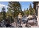 Spacious deck overlooking the mountain and forest with comfortable seating at 26806 Evergreen Springs Rd, Evergreen, CO 80439