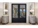 Elegant entryway featuring glass paneled double doors leading to outdoor patio, flanked by mirrored sideboards at 26806 Evergreen Springs Rd, Evergreen, CO 80439