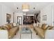 Inviting living room featuring neutral tones, symmetrical furniture arrangement and stylish bar area perfect for entertaining at 26806 Evergreen Springs Rd, Evergreen, CO 80439