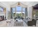 Bright living room with fireplace, vaulted ceilings, large windows, and mountain views at 26806 Evergreen Springs Rd, Evergreen, CO 80439