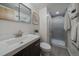 A tiled full bathroom with shower stall, modern vanity and mirror at 1050 N Corona St # 202, Denver, CO 80218