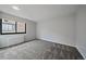 A well lit bedroom with carpet, light grey walls, and large window at 1050 N Corona St # 202, Denver, CO 80218