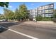 Modern apartment building with mature trees and underground parking at 1050 N Corona St # 202, Denver, CO 80218