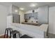 Updated kitchen featuring sleek gray cabinetry, stainless appliances, and a breakfast bar for casual dining at 1050 N Corona St # 202, Denver, CO 80218