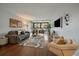 Bright living room with hardwood floors, neutral decor, balcony access, and comfortable seating arrangements at 1050 N Corona St # 202, Denver, CO 80218