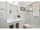 Elegant bathroom with a white vanity, framed mirror, and a shower with sleek subway tile at 2633 Quitman St, Denver, CO 80212