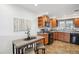 Charming kitchen with wood cabinetry, stainless steel appliances, and an adjacent dining area at 2633 Quitman St, Denver, CO 80212