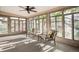 Light-filled sunroom with floor-to-ceiling windows and comfortable seating at 2633 Quitman St, Denver, CO 80212
