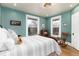 Tranquil bedroom featuring hardwood floors, bright windows, and a comfortable bed with decorative pillows at 1614 Gaylord St, Denver, CO 80206