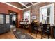 Dining area with table, chairs, exposed brick, and wood floors at 1614 Gaylord St, Denver, CO 80206