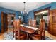 Formal dining room with wood table set, decorative chandelier, and doorway view at 1614 Gaylord St, Denver, CO 80206