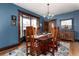 Elegant dining room with hardwood table, chairs, chandelier, and bay window at 1614 Gaylord St, Denver, CO 80206