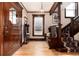 Spacious foyer with gleaming wood floors, a wooden staircase, and a classic chandelier at 1614 Gaylord St, Denver, CO 80206