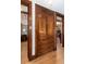 Hallway with built-in wooden cabinet and drawers, complemented by hardwood floors and doorways to other rooms at 1614 Gaylord St, Denver, CO 80206