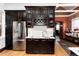 Kitchenette featuring a wine rack, stainless fridge, bright countertop, and dark wood cabinets at 1614 Gaylord St, Denver, CO 80206