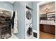 Convenient laundry area equipped with a washer, dryer, and organized closet space at 1614 Gaylord St, Denver, CO 80206