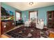 Cozy living room featuring stylish armchairs, piano, and large windows at 1614 Gaylord St, Denver, CO 80206