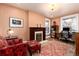 Cozy living room with fireplace, plush seating, vintage rug, and natural light from nearby windows at 1614 Gaylord St, Denver, CO 80206