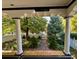 View from the porch showcasing stately columns and the inviting landscape of the front yard at 1614 Gaylord St, Denver, CO 80206