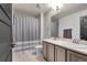 Bright bathroom featuring a double sink vanity, a shower with a stylish curtain, and modern fixtures at 20727 Park Hollow Dr, Parker, CO 80138