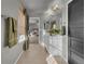 Hall bathroom with tile flooring, dual sink vanity, and modern fixtures at 20727 Park Hollow Dr, Parker, CO 80138