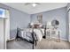 Comfortable bedroom features a dark metal bed frame, a stylish vanity, and a light blue wall color at 20727 Park Hollow Dr, Parker, CO 80138