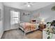 Cozy bedroom with a white metal bed frame, a plush rug, lots of light, and neutral decor at 20727 Park Hollow Dr, Parker, CO 80138