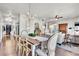 Bright dining room features a farmhouse table and chandelier, adjacent to living area at 20727 Park Hollow Dr, Parker, CO 80138