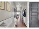 Long hallway featuring hardwood floors, multiple doors, bench, and stylish decor at 20727 Park Hollow Dr, Parker, CO 80138