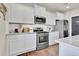 Modern kitchen with white cabinets, stainless steel appliances and granite countertops at 20727 Park Hollow Dr, Parker, CO 80138