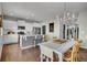 Open concept kitchen flows into dining area, featuring white cabinets and a breakfast bar at 20727 Park Hollow Dr, Parker, CO 80138