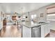 Open kitchen island with granite countertop and stainless steel dishwasher overlooks living room at 20727 Park Hollow Dr, Parker, CO 80138