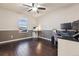Bedroom or office area with dark wood flooring, a desk, and a window offering natural light at 2785 S Lisbon Way, Aurora, CO 80013