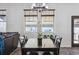 Inviting dining area with a modern chandelier, and large windows with natural light at 2785 S Lisbon Way, Aurora, CO 80013
